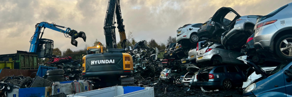 Cars being crushed at Scrap Local's scrapyard