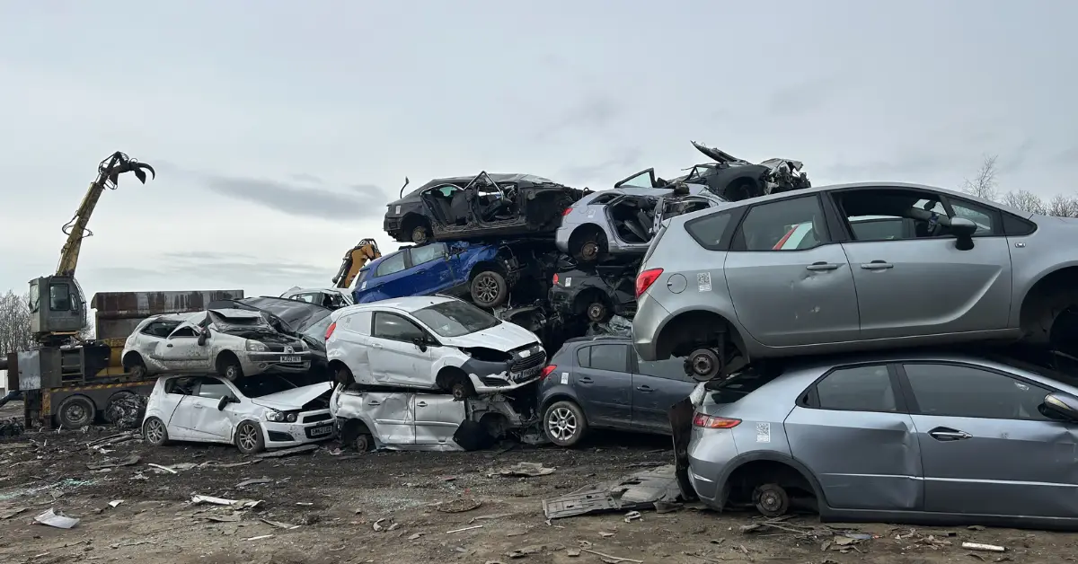 Stacked scrapped cars in industrial scrapyard