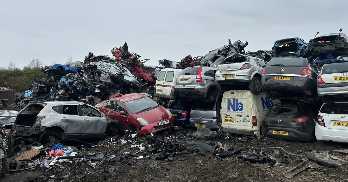 Scrapyard with stacked and crushed cars