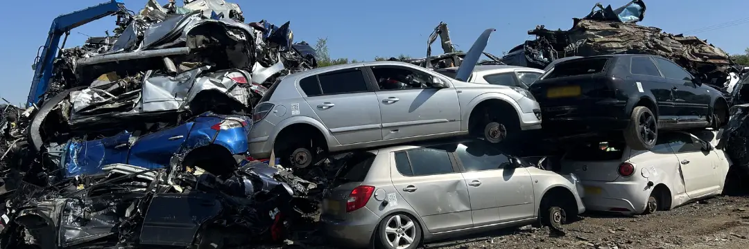 Stacked scrap cars in a scrapyard